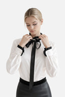 ANI ARPÉ white cotton long-sleeve shirt with black pleated collar, cuffs, and removable bow tie.